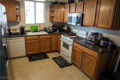 Kitchen featuring white appliances, open shelves,