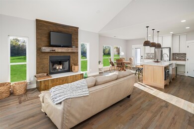 Living room featuring a large fireplace, dark hard