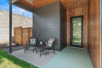 View of exterior entry with a patio