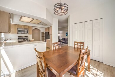 Dining space with arched walkways, light wood-styl