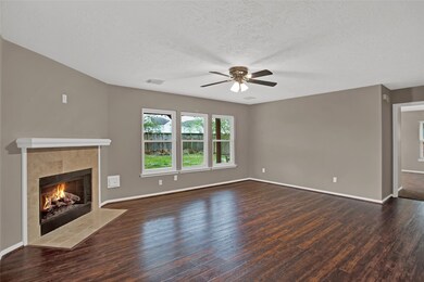 Spacious family room with stunning hardwood floor and abundant natural light provided coming through the three windows.