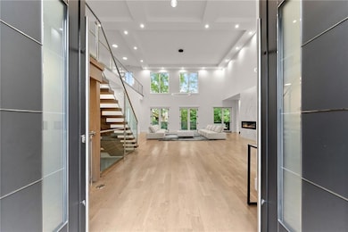 Hallway featuring light wood-type flooring and a t