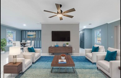 Living room with ceiling fan and ornamental moldin