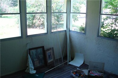Enclosed back porch gives access to utility room that is large enough for W/D Freezer