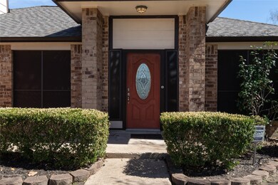 A covered entry leads to the wood and leaded-glass front door.