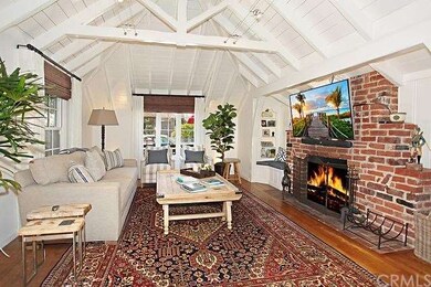 Inviting living room with hardwood floors, beamed 