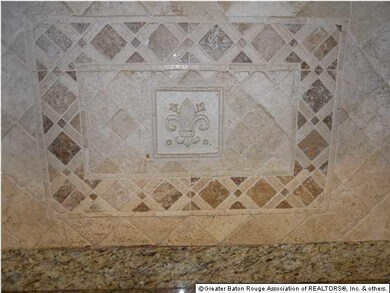 Tumbled marble inset over cooktop
