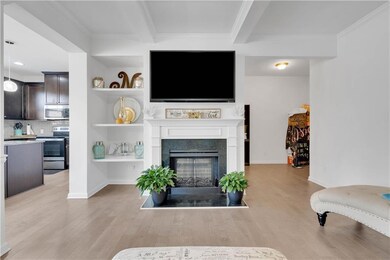 Living room with ornamental molding, light wood-ty