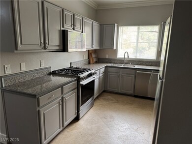Kitchen featuring crown molding, gray cabinets, ap