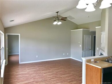 Family room with vaulted ceiling and plant ledges.