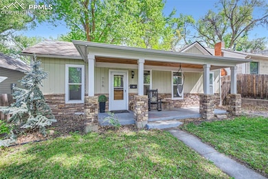 View of front facade with stone siding and a porch