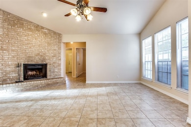 Unfurnished living room featuring vaulted ceiling