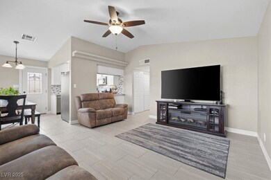 Living room with visible vents, baseboards, a ceil