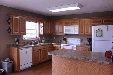 The kitchen with lots of counter space and cabinets for storage. The counters have a granite look to them. 9x13