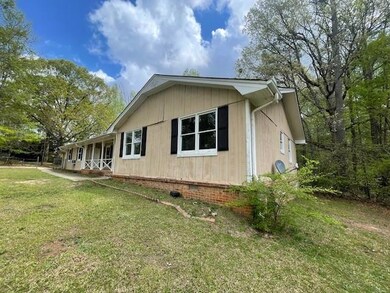 View of property exterior featuring a lawn and crawl space