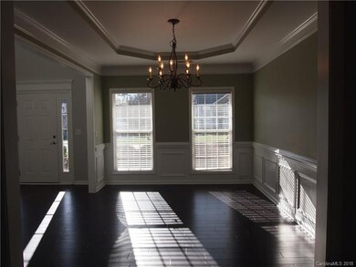 The dining room boasts crown, chair rail and a tre