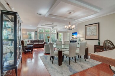 Dining room with a tray ceiling, dark hardwood / w