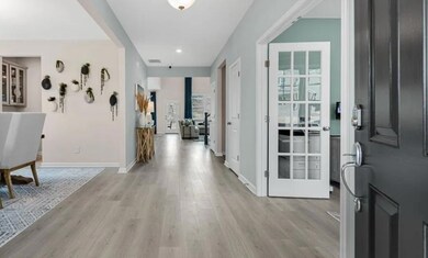 Foyer featuring light wood-style floors and baseboards