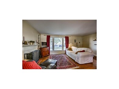 Fireplace has built-in shelves on either side.