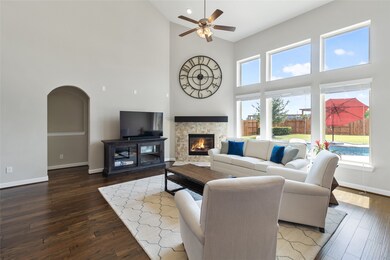 This living room is more like a GREAT room featuring a stunning fireplace with mantel detailing, custom paint, gorgeous flooring, high ceilings and large windows providing a lovely view of your backyard oasis.