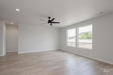 Empty room with light wood-type flooring, recessed lighting, and a ceiling fan