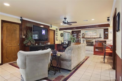 Den-note fireplace and opens to kitchen