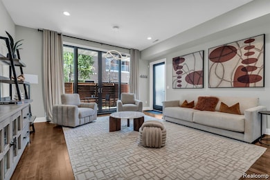 Living area with french doors, dark wood-style floors, and recessed lighting