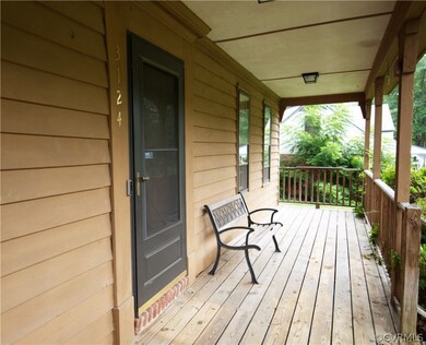 Full country front porch awaits your rocking chair