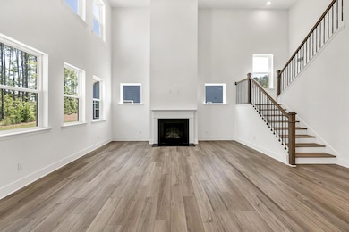 Soaring two story family room with centered gas fireplace