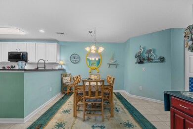 Dining area featuring light tile patterned floors, a chandelier, and recessed lighting