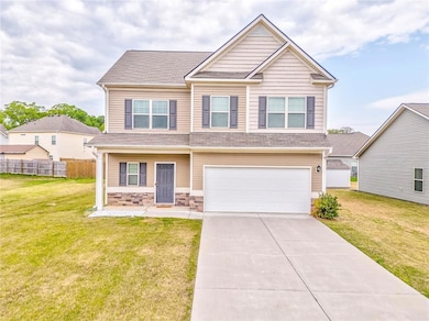 Craftsman inspired home with a garage, a front yar