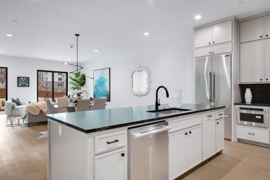 Kitchen featuring a kitchen island with sink, a si
