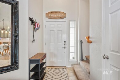 Entryway with healthy amount of natural light and light tile patterned floors
