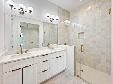 Full bathroom with a stall shower and double vani