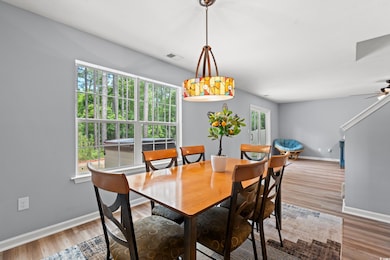 Dining area with ceiling fan, baseboards, visible 