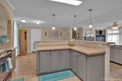 Kitchen with ceiling fan, light tile floors, gray 