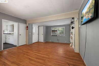Unfurnished living room featuring dark wood-style floors and cooling unit