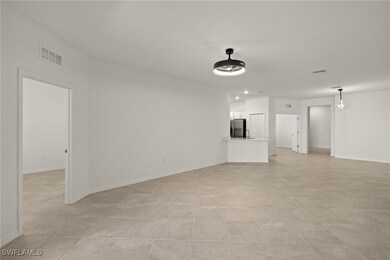 Unfurnished living room with baseboards and visibl