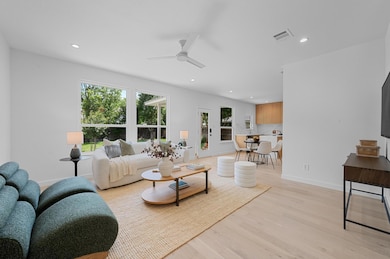 Living room with light wood finished floors, a ce