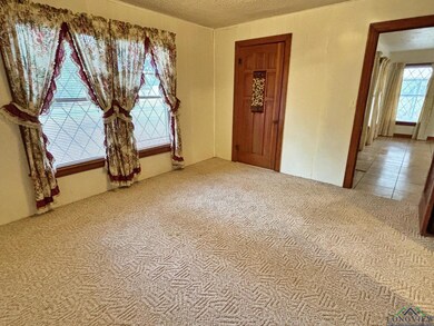 Carpeted empty room featuring a textured ceiling