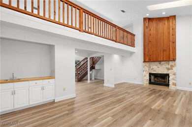 Unfurnished living room featuring stairs, recessed