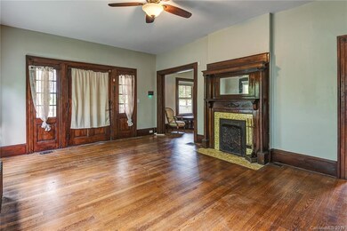 Interior view of entry, and first of tri-facing tiled fireplace and mantle.