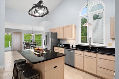 Kitchen has vaulted ceiling, ceramic tile flooring