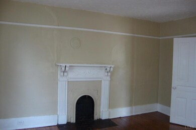 SPACIOUS LIVING ROOM WITH HARDWOOD FLOORS.