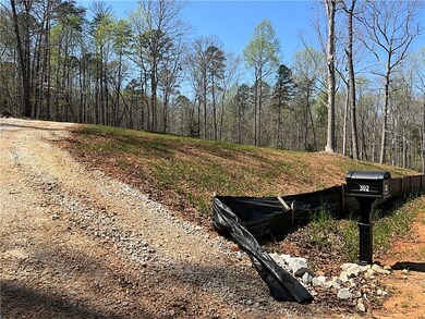 View from further down the driveway showing slope toward road