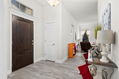 Entrance foyer featuring light wood-style flooring and baseboards