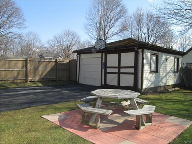Paved driveway leads to a 2-car garage.
