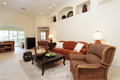 Living room featuring ceiling fan, a towering ceil