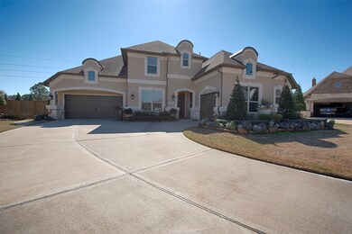 Home has huge driveway with curve to both a 2 car garage and secondary one car garage. 