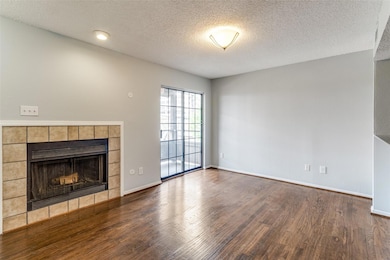 Unfurnished living room featuring a tile fireplace